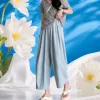 A casual summer look for women with light blue loose trousers paired with a grey top Specification image